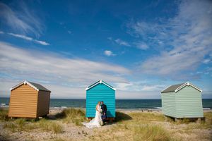 wedding couple beside  beach huts