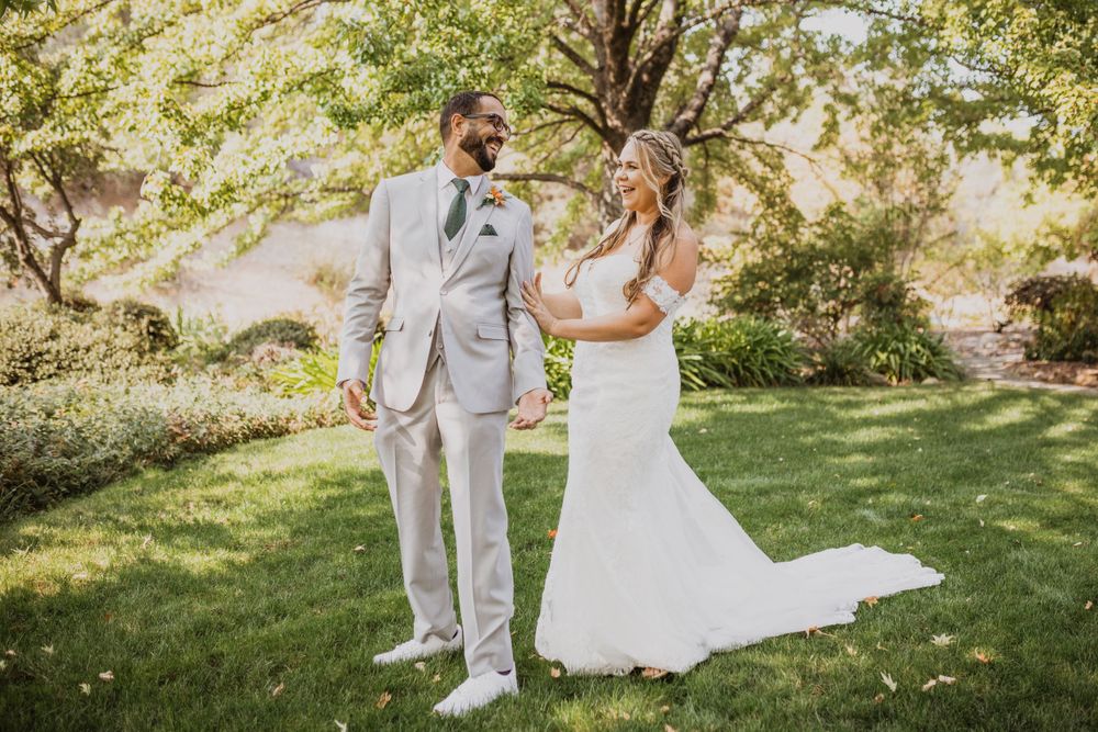 Romantic first look moment between couple in garden setting with natural lighting.