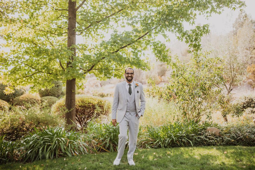 Wedding party photographs in a scenic garden setting with natural lighting.