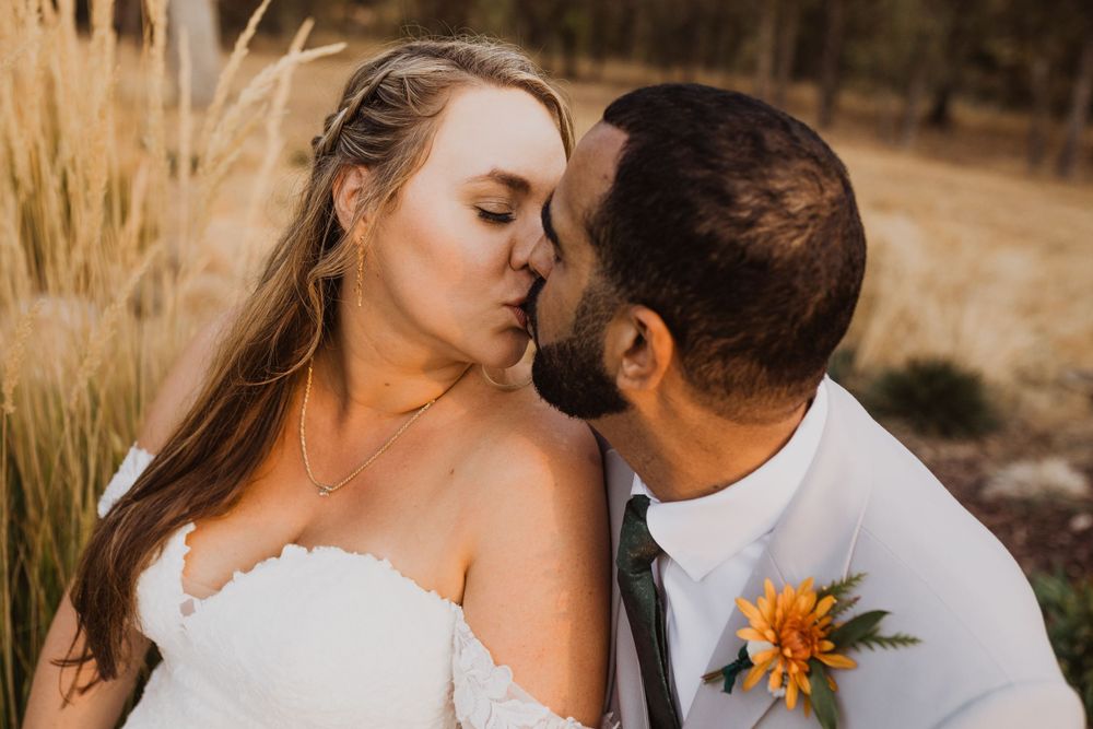 Romantic wedding couple shares intimate moments during sunset portrait session.