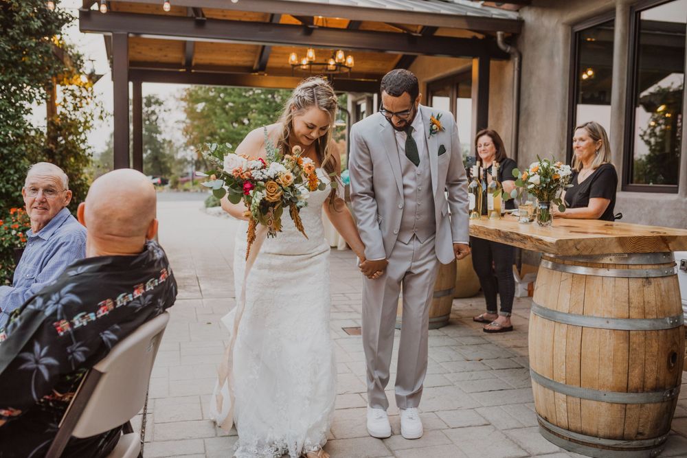 A beautiful wedding celebration with rustic wine barrel decor and floral arrangements.