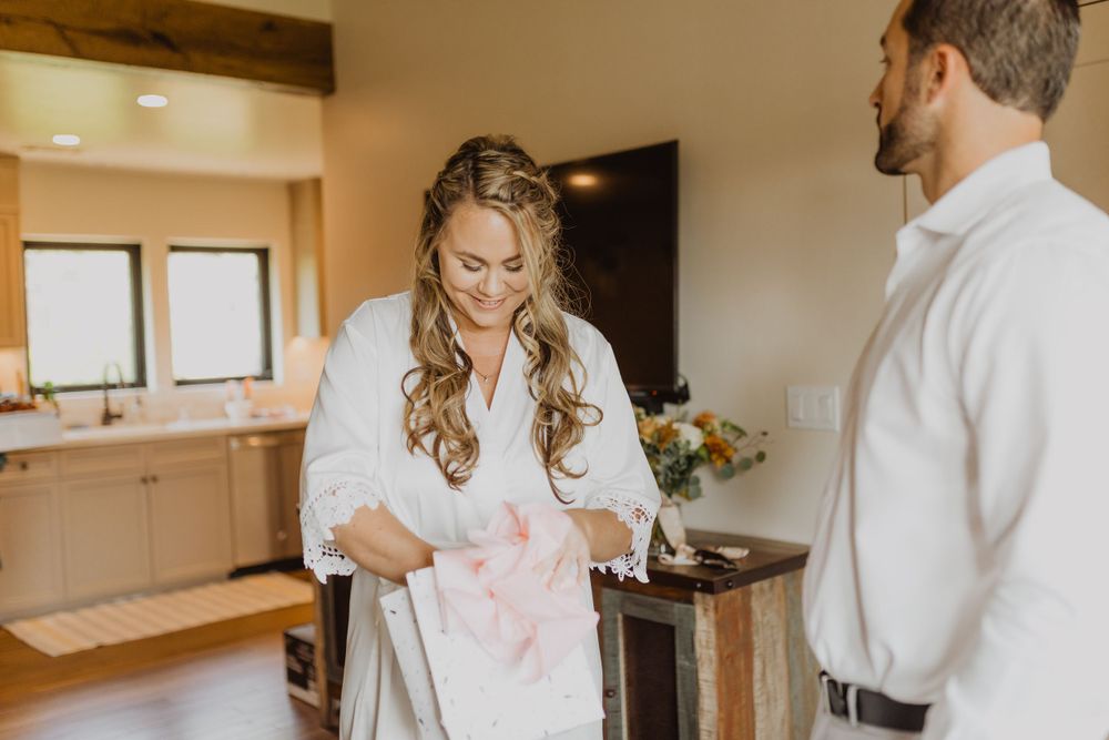 Bridal party members share joyful moments while getting ready in matching robes.