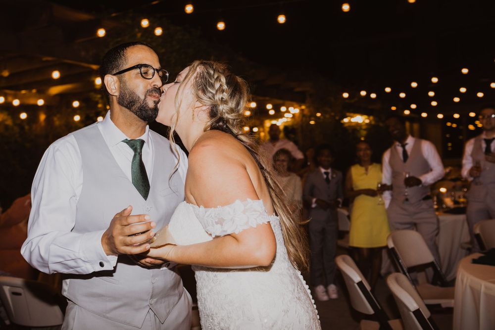 Romantic evening wedding reception with string lights illuminating the celebration.