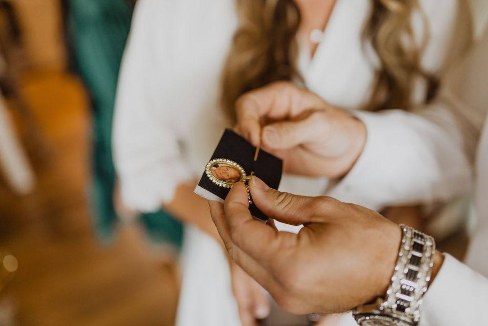 Wedding party members share emotional embraces during preparation time.