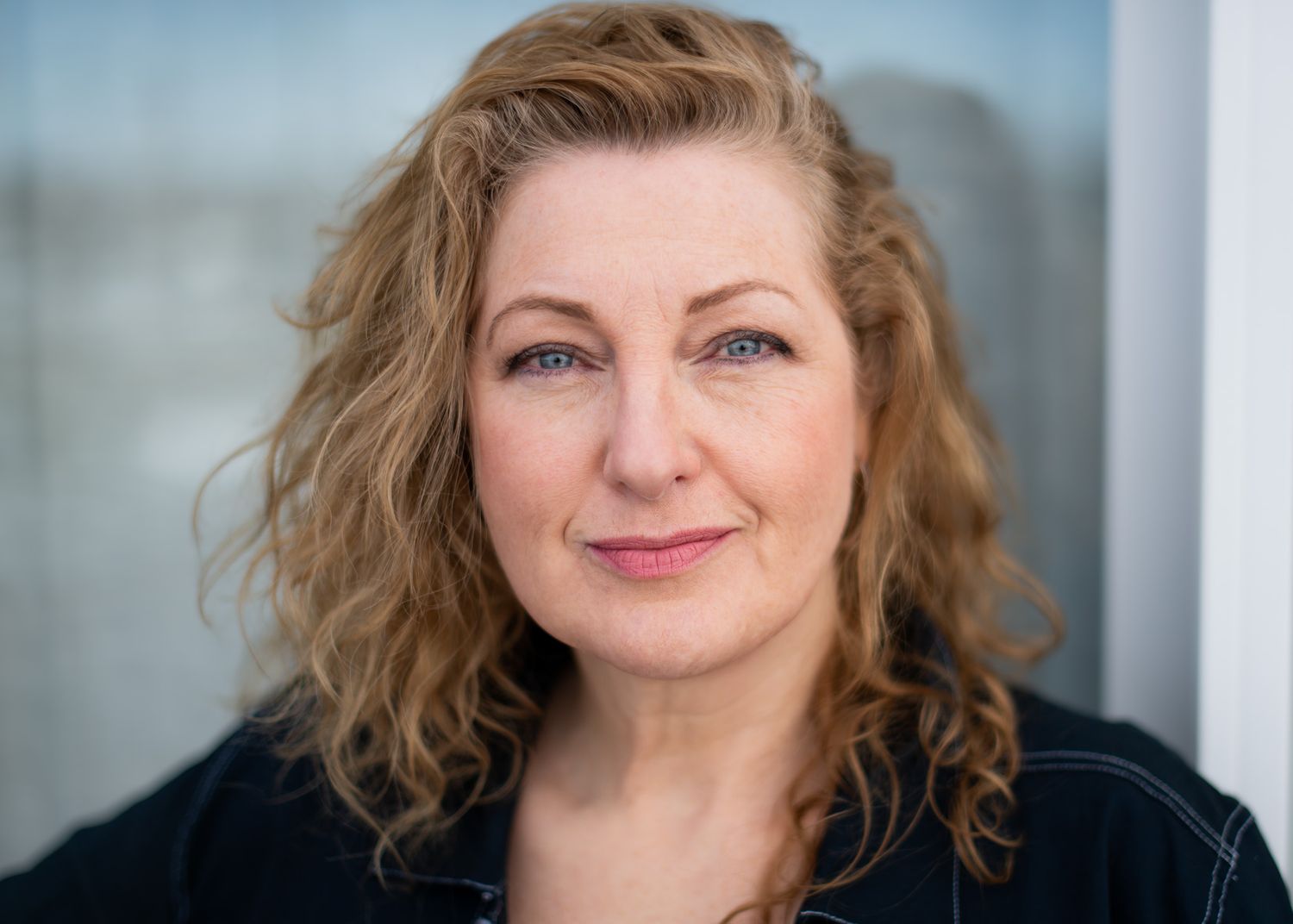 A pale blue eyes woman in a blouse