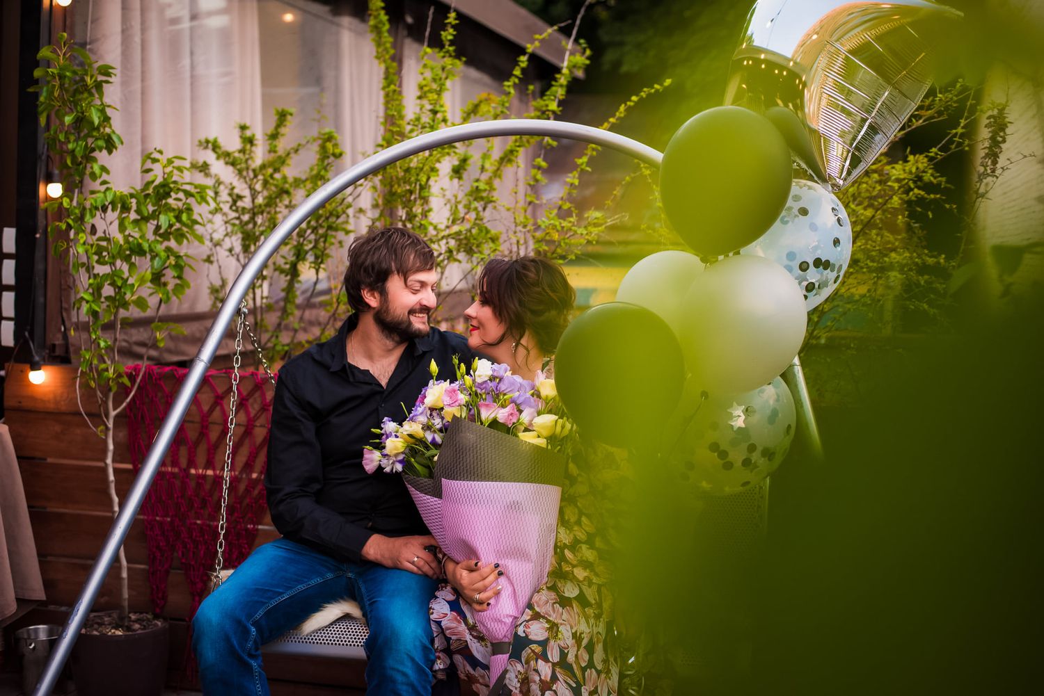 Outdoor portrait session with decorative arch and soft lighting.