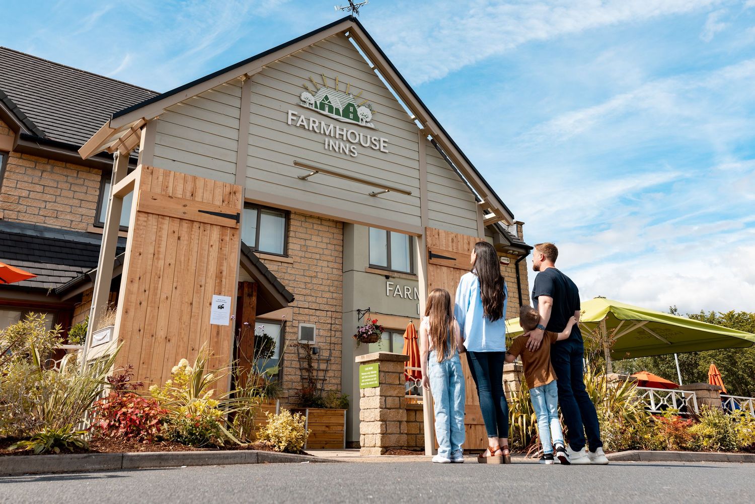 Family greeting outside a countryside pub restaurant on a sunny day, hospitality venue lifestyle photography Southampton