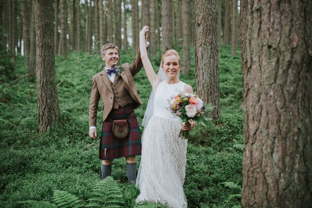 bride and groom dancing in the woods, groom wearing a kilt, bride with bouquet