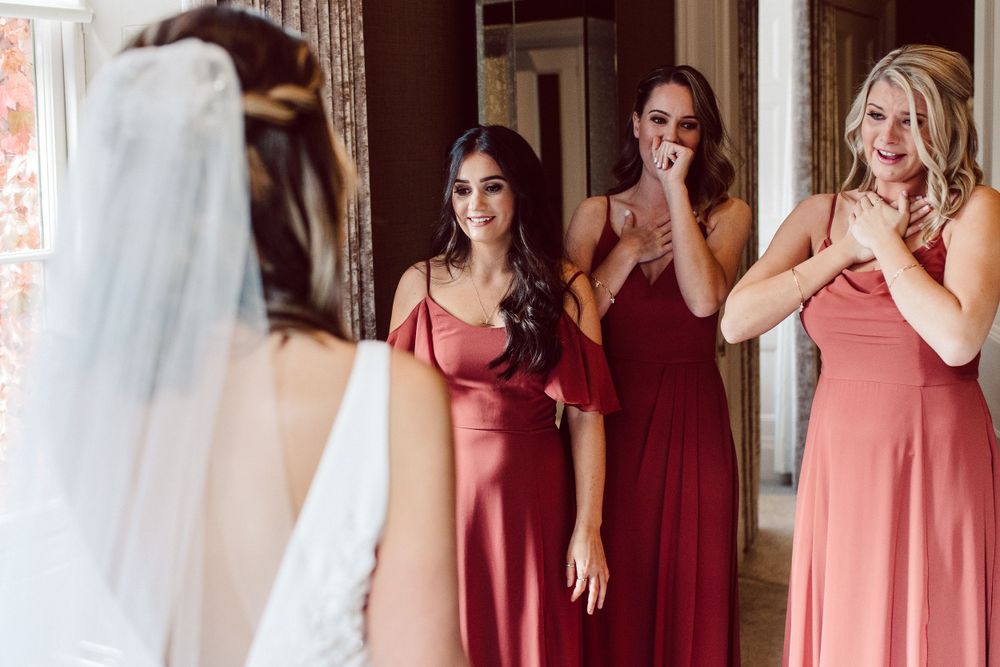 bridesmaids cry for joy as they see the bride for the first time