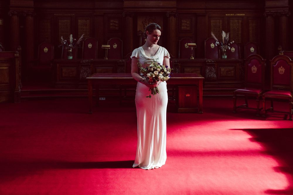 Bride in a church with her bouquet in gorgeous light