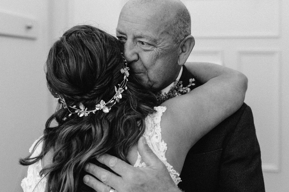Intimate black and white wedding moment captured indoors.