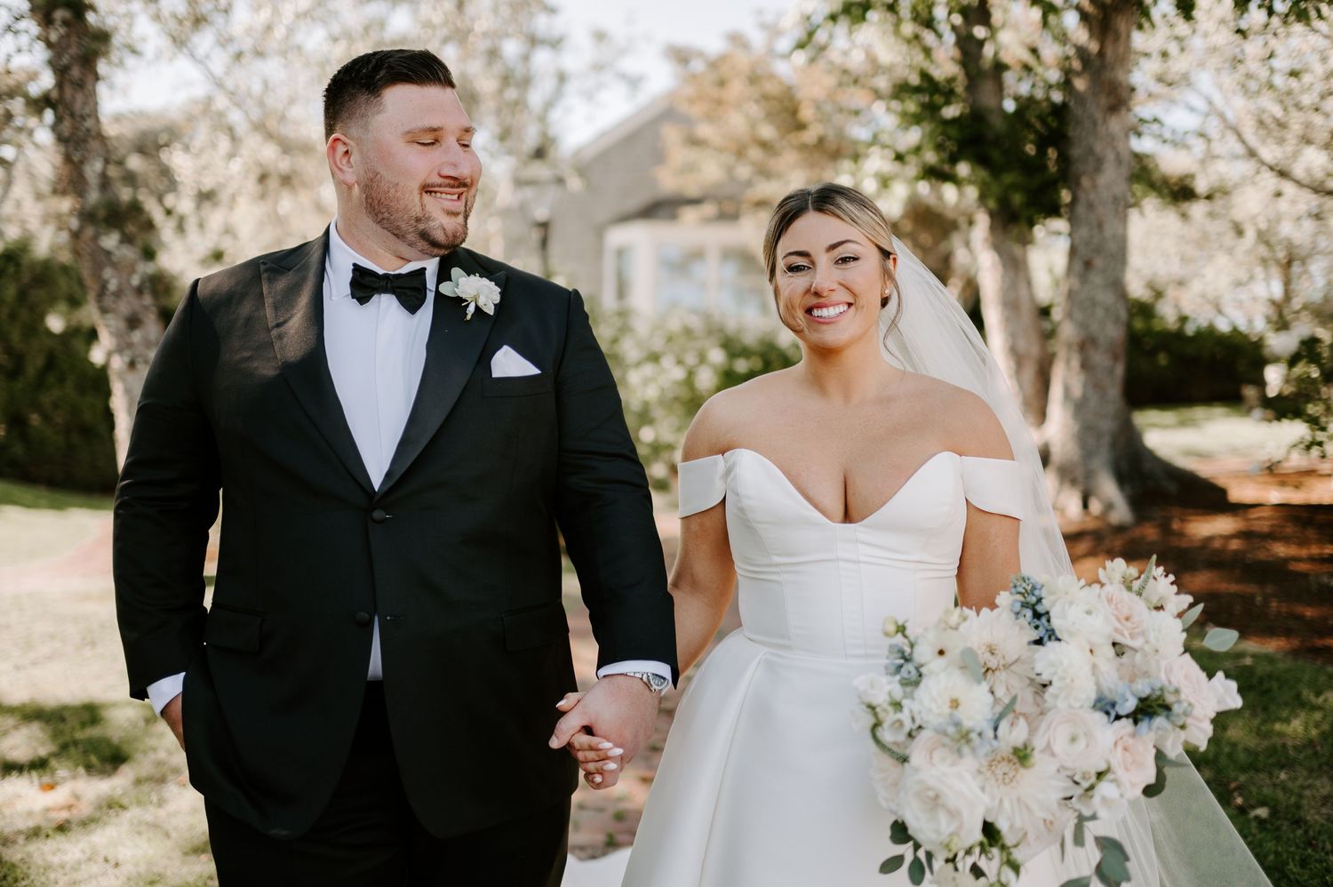 Elegant wedding couple shares tender moments during outdoor portrait session.