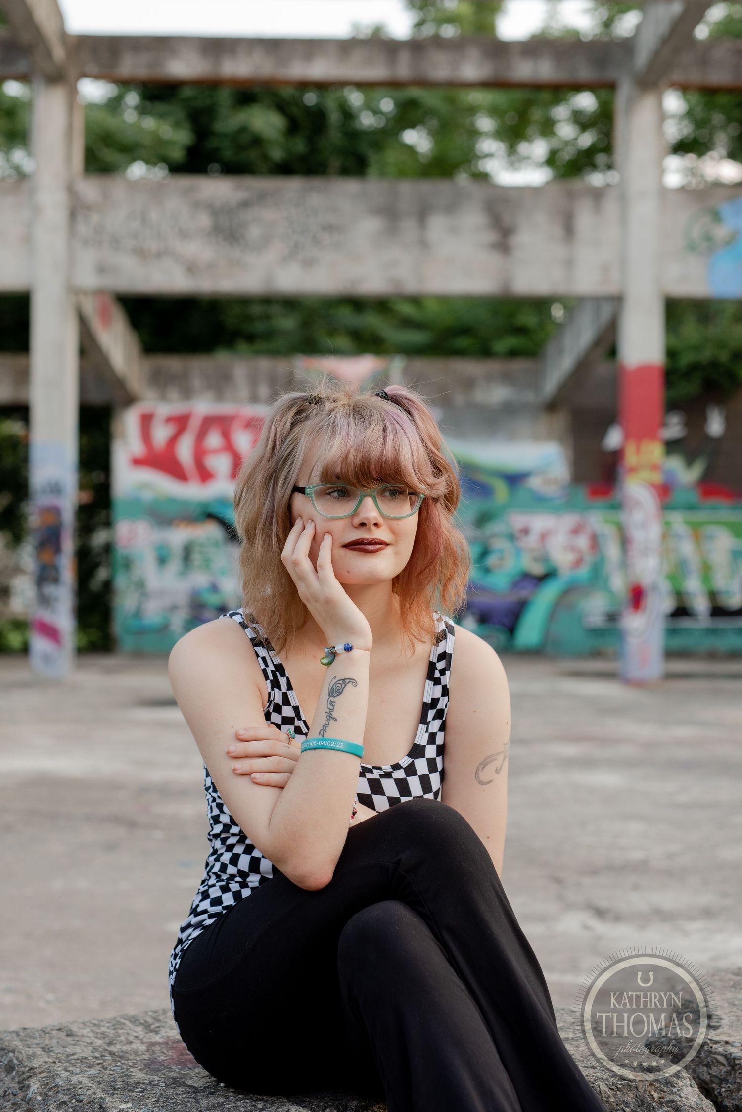 Stylish portrait session featuring checkered pattern outfit against colorful graffiti backdrop.