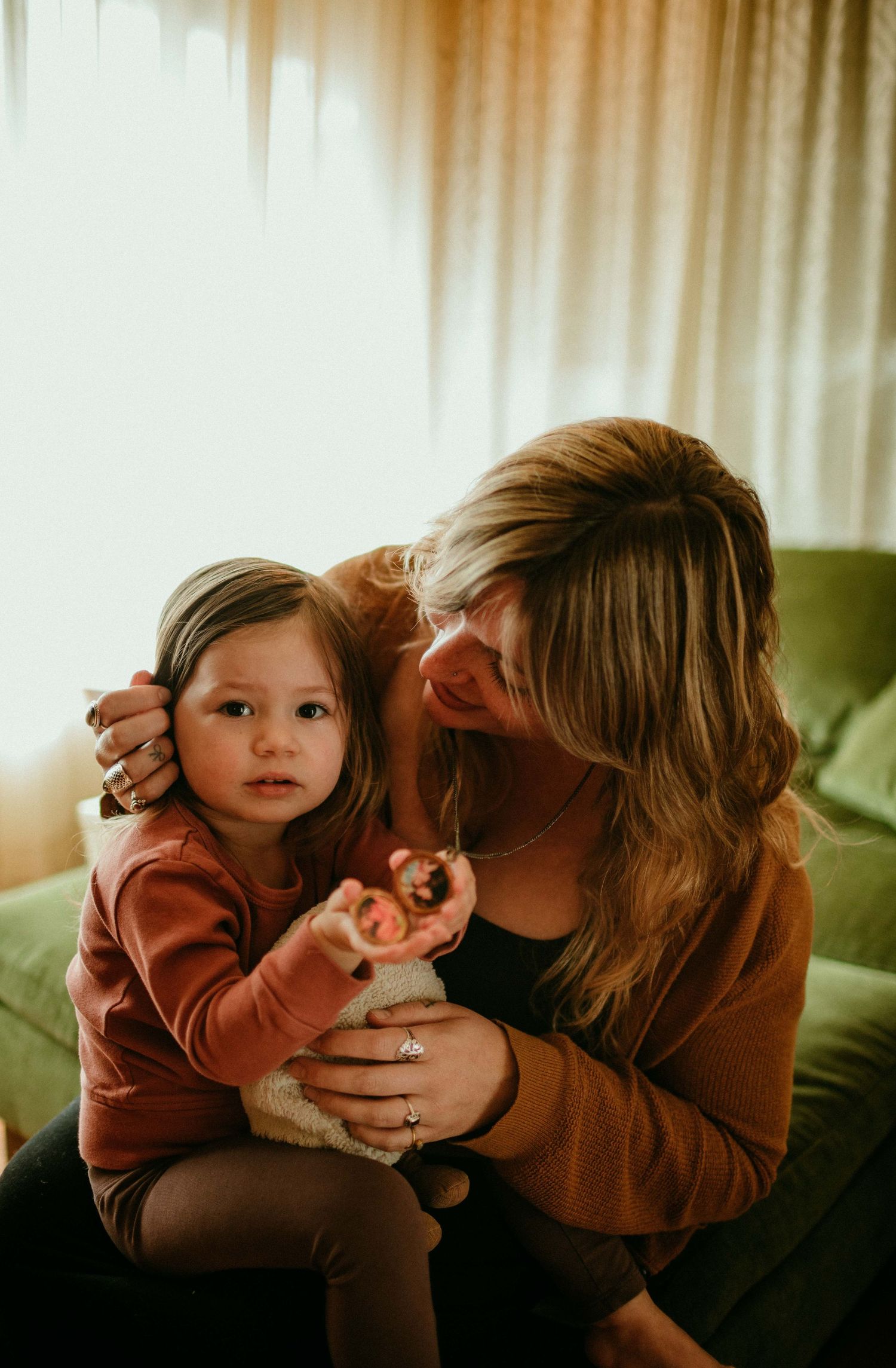 mother looks at child who is looking at camera home family photography session portland oregon