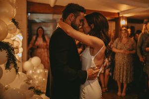 Intimate wedding reception celebration with warm ambient lighting and floral decor.
