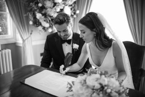 Wedding party signing documents during the marriage ceremony.