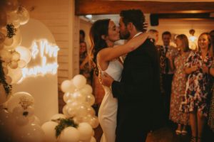 Romantic wedding reception with soft lighting and white balloon decorations.
