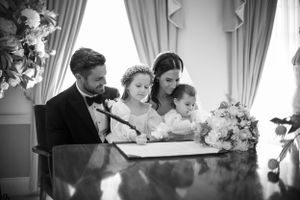 Wedding guests gathered around a table during the ceremony proceedings.