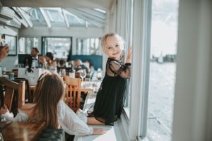 Bright waterfront wedding venue with large windows overlooking the ocean.
