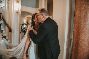 Emotional wedding ceremony moments captured in a luxurious indoor setting.