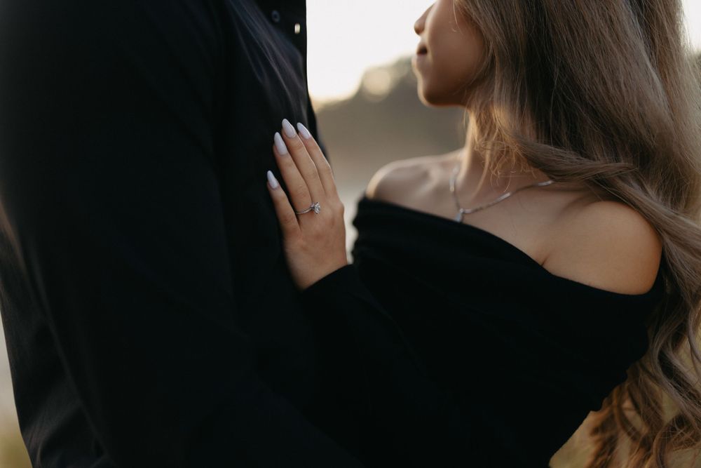 Close-up detail of delicate lace and fabric on elegant formal attire.