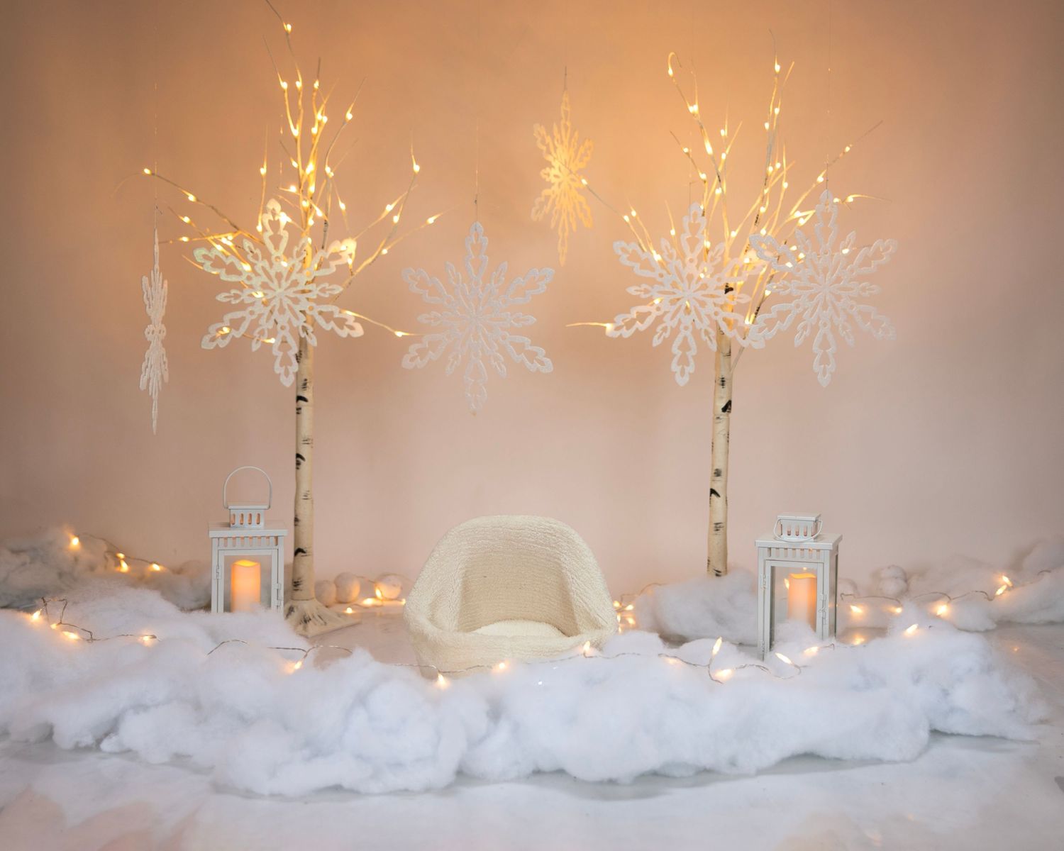 Elegant winter party scene with illuminated snowflake decorations and white cotton snow backdrop.