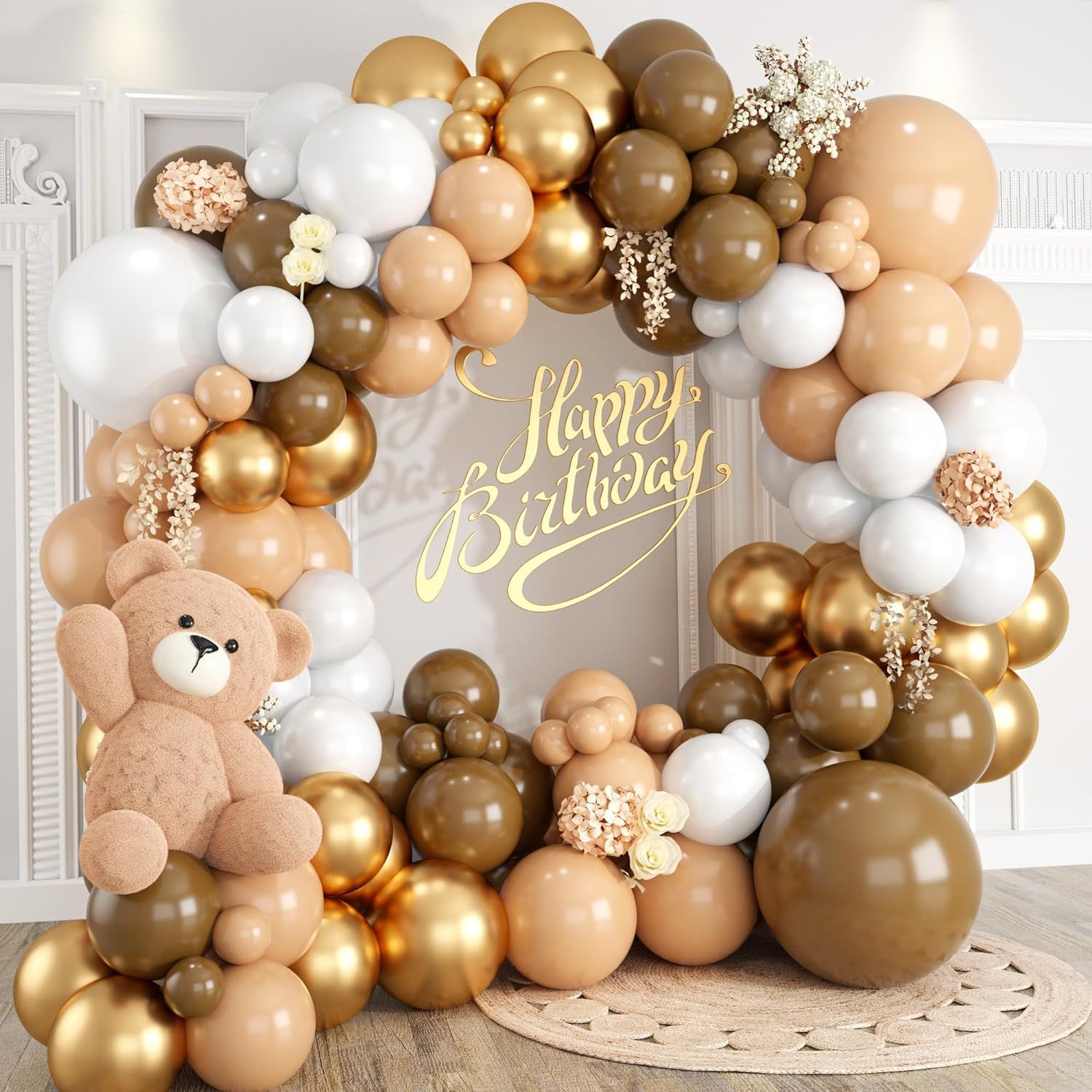 Baby shower decoration featuring balloon arch with teddy bears in gold and neutral colors.