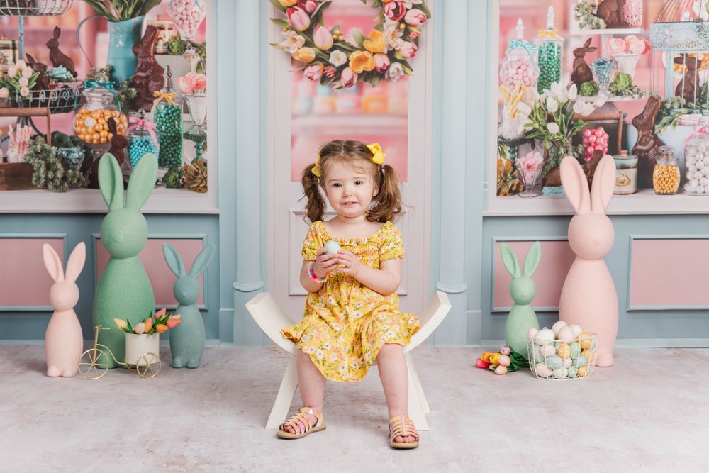 Easter themed photo setup with pastel decorations, bunnies, and flowers.