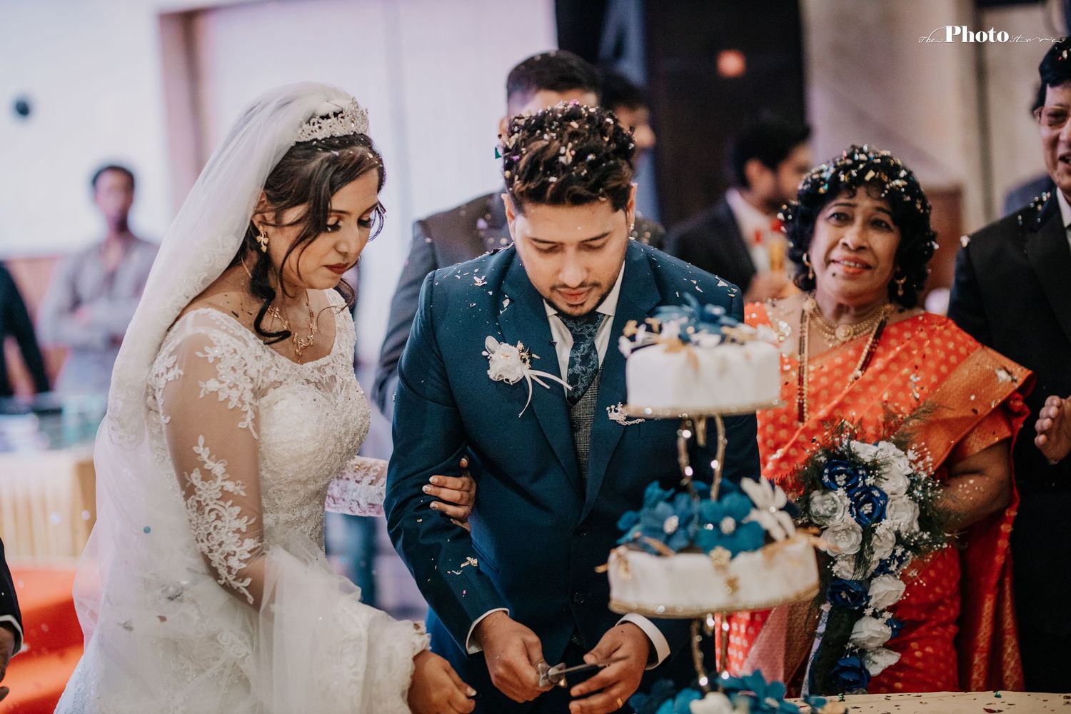 Wedding celebration with blue confetti and string lights creating a magical atmosphere.