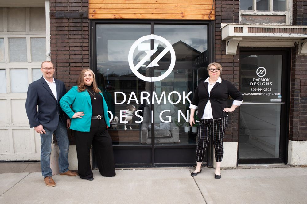 Team members posing in front of Darmok Design business storefront. Quad Cities Business Headshot Photography