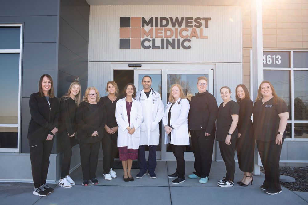 Medical staff posing outside Midwest Clinic building entrance. Quad Cities Business Headshot Photography