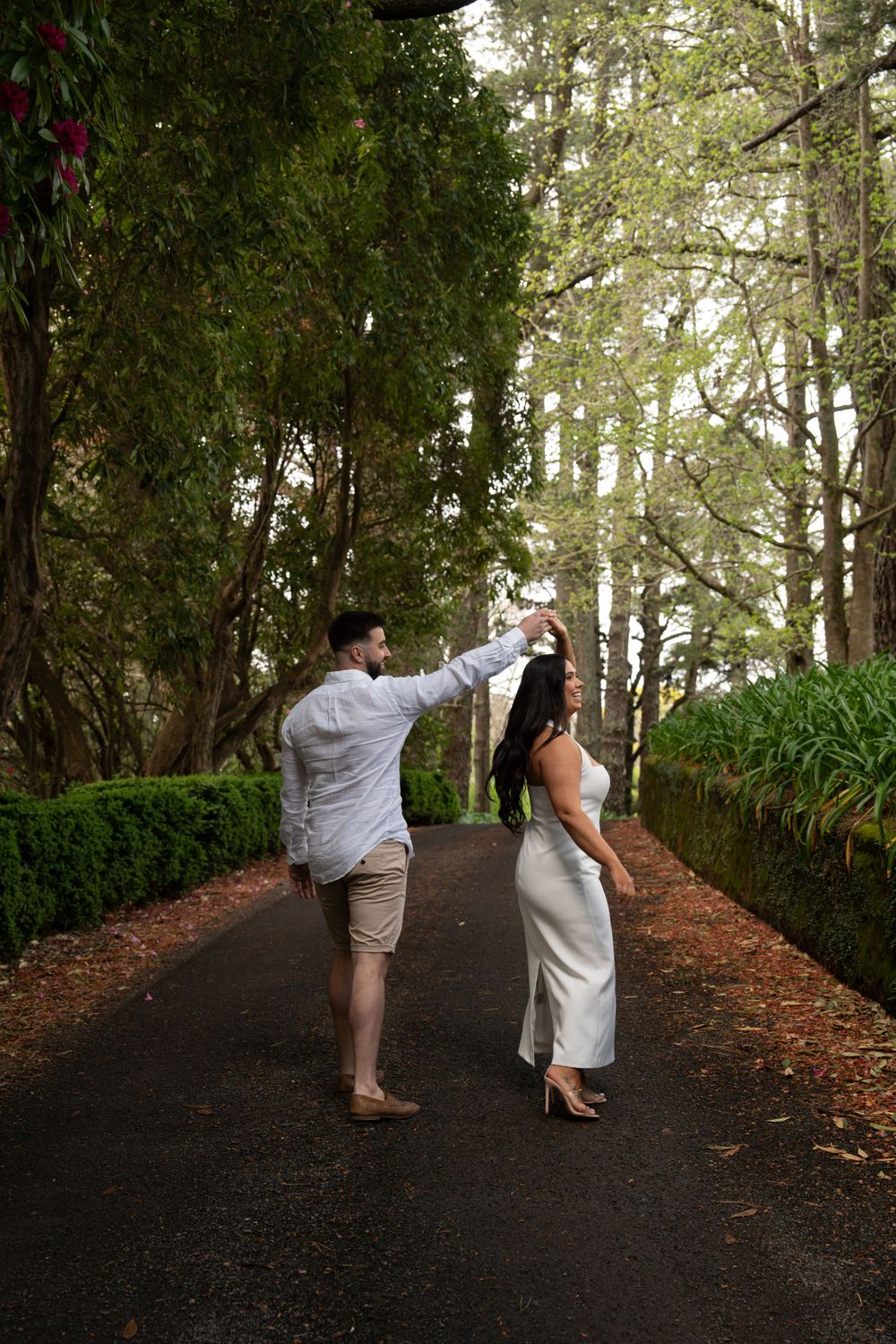 Engagement photography of couple dancing on road