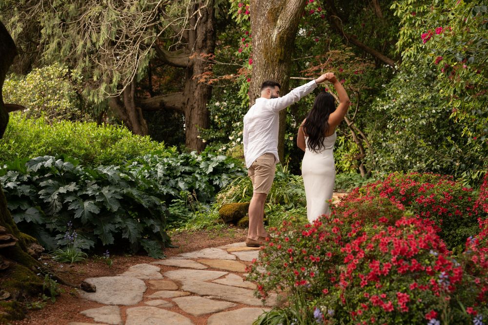 engaged couple dancing in a garden that looks like a fairytale