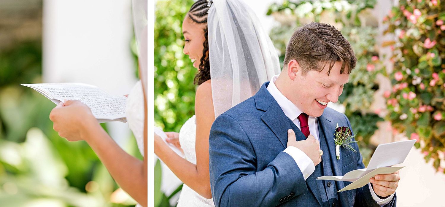A groom in a navy suit reads from a paper during an outdoor wedding ceremony.