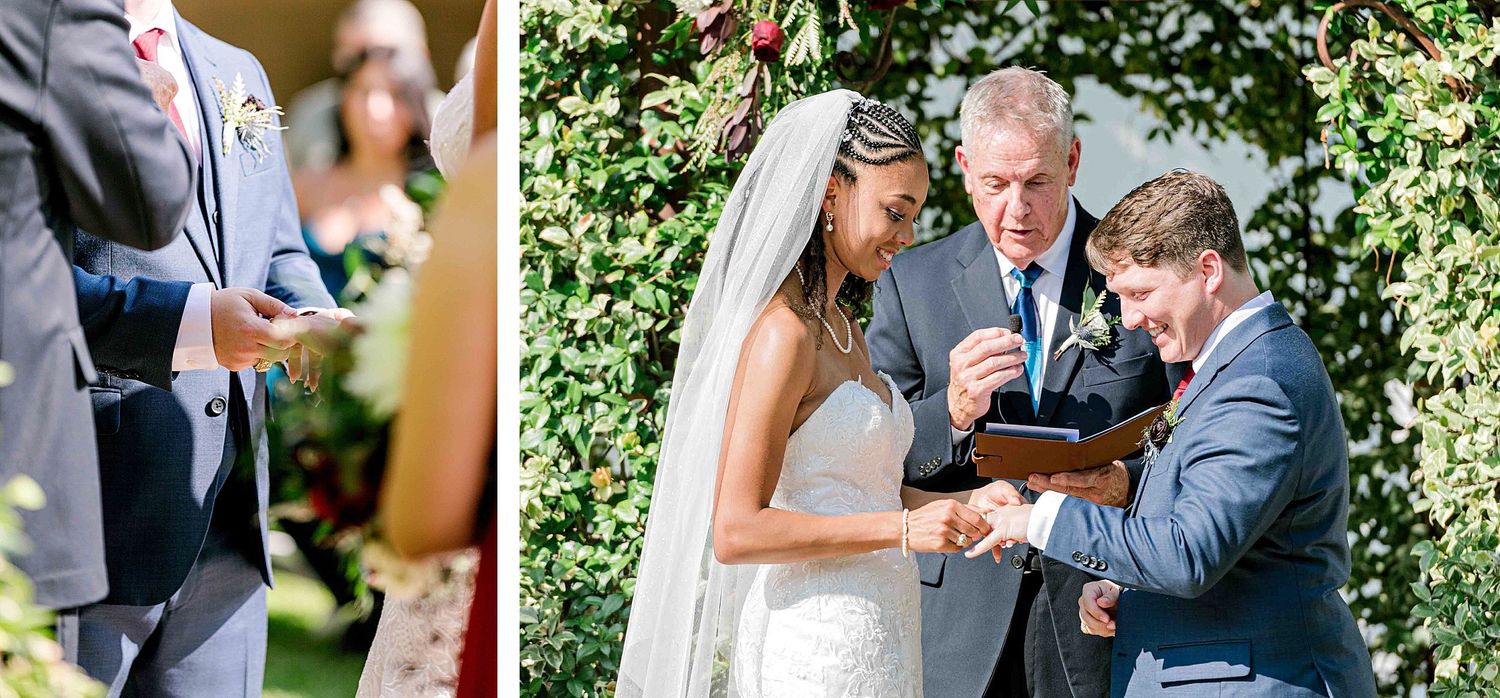 An intimate moment during a wedding ring exchange under a floral archway.