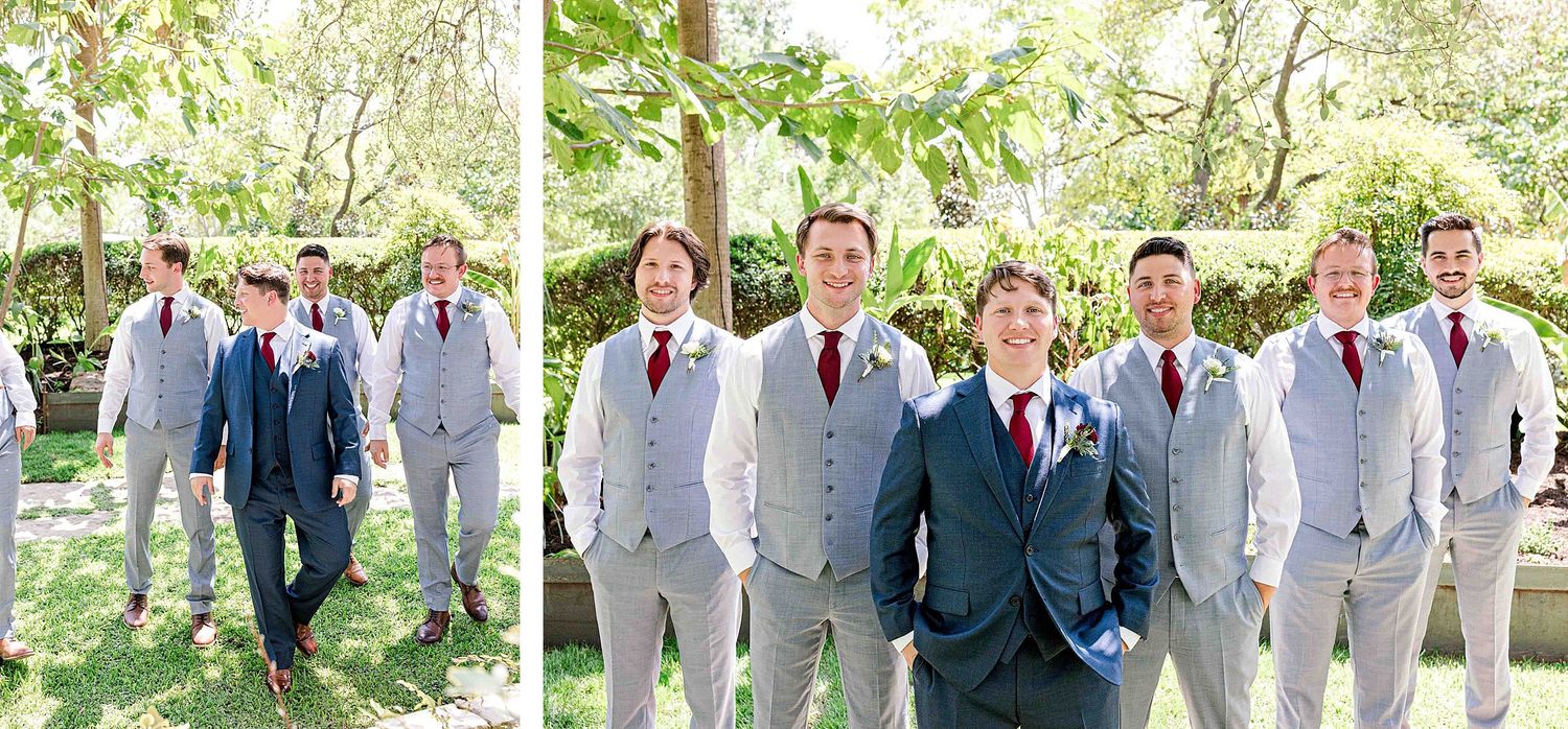 Groomsmen walking in coordinated grey and navy suits through a garden pathway.