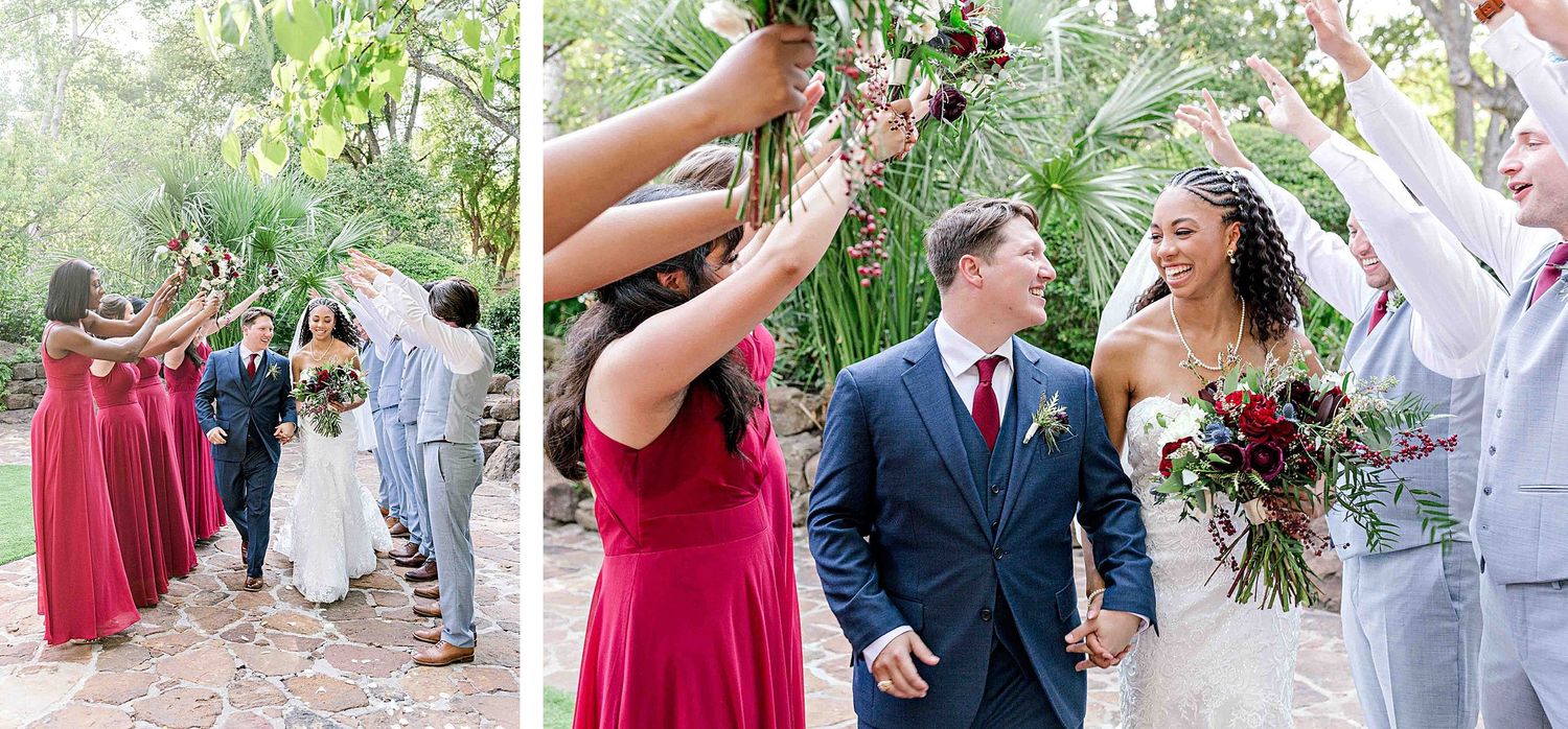 Wedding celebration with bridal party in red dresses and gray suits walking together through a garden pathway.