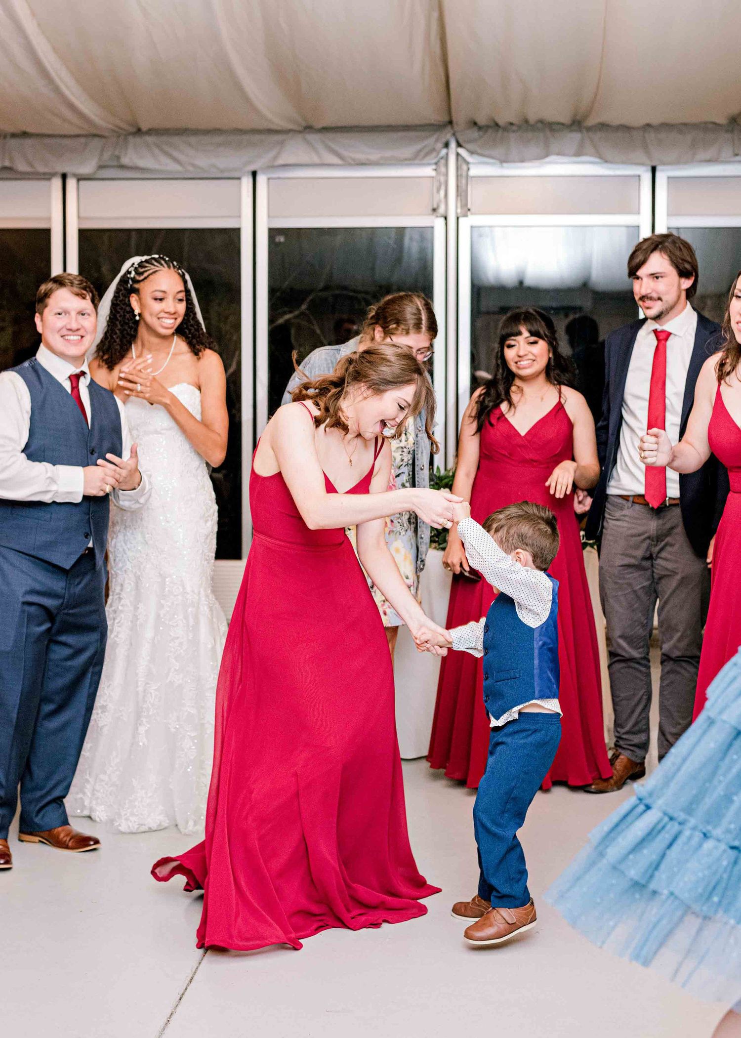Wedding party members interacting with guests during reception festivities.