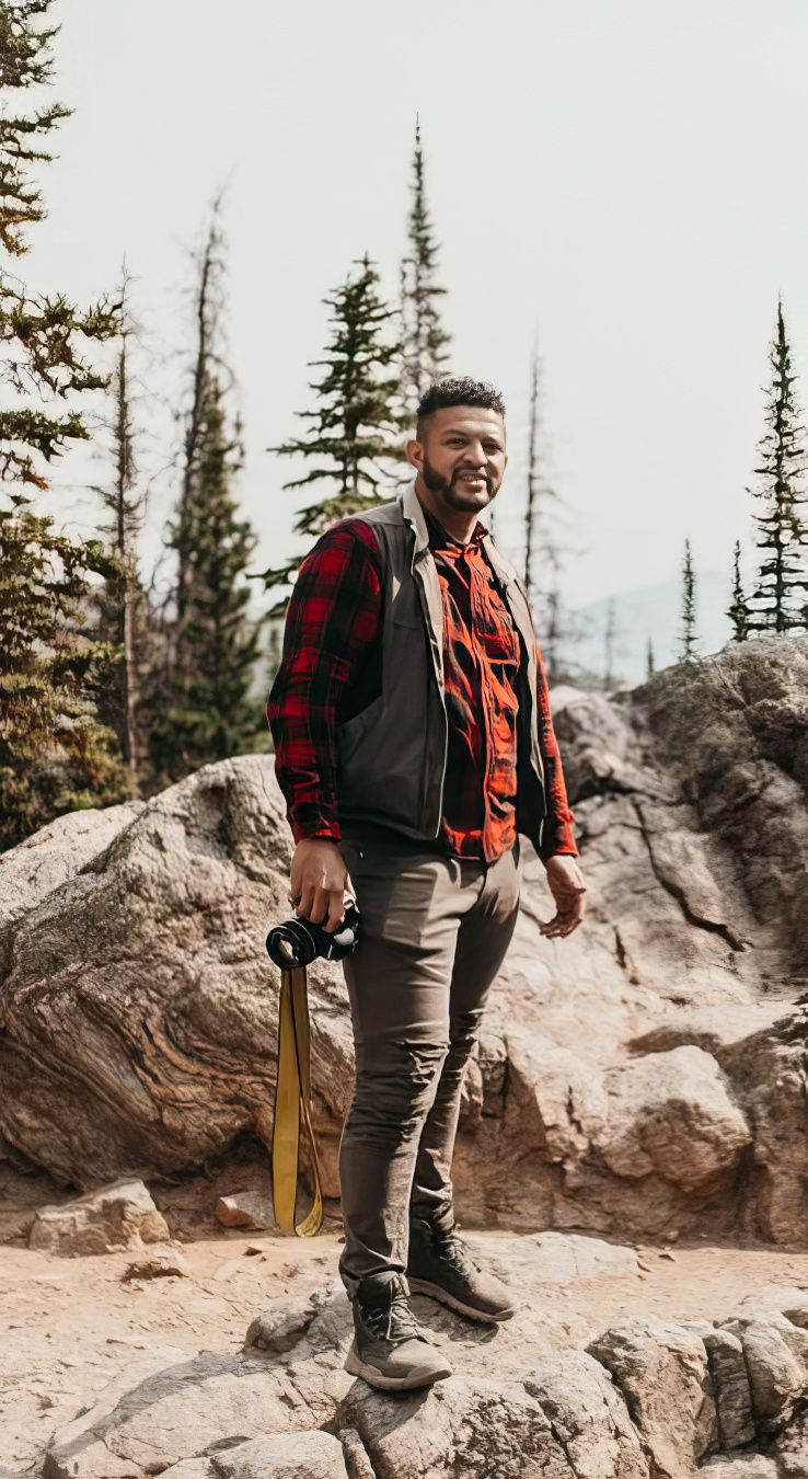 photographer on mountain hiking with camera