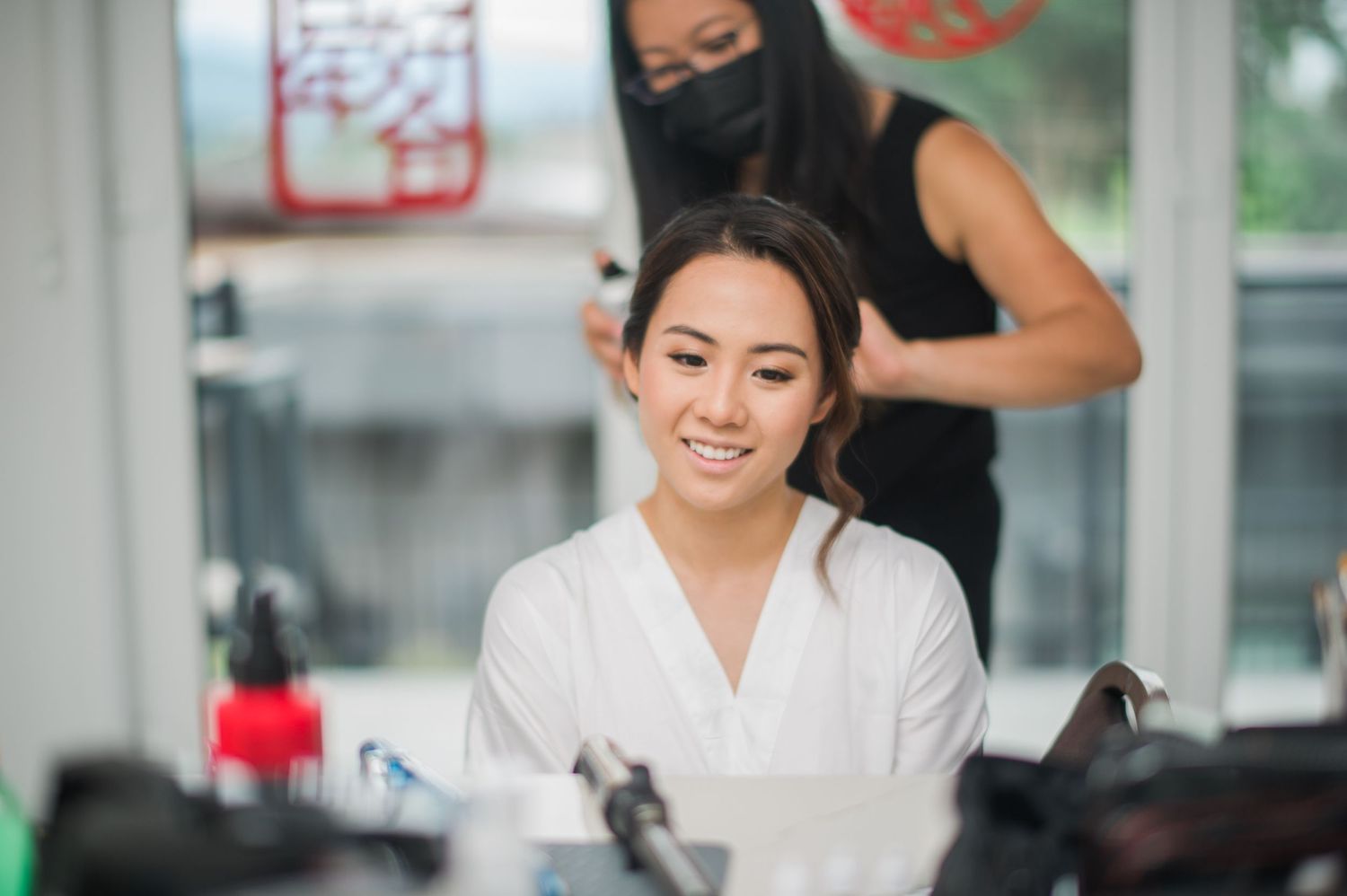 Client getting hair styled in salon chair during beauty preparation.