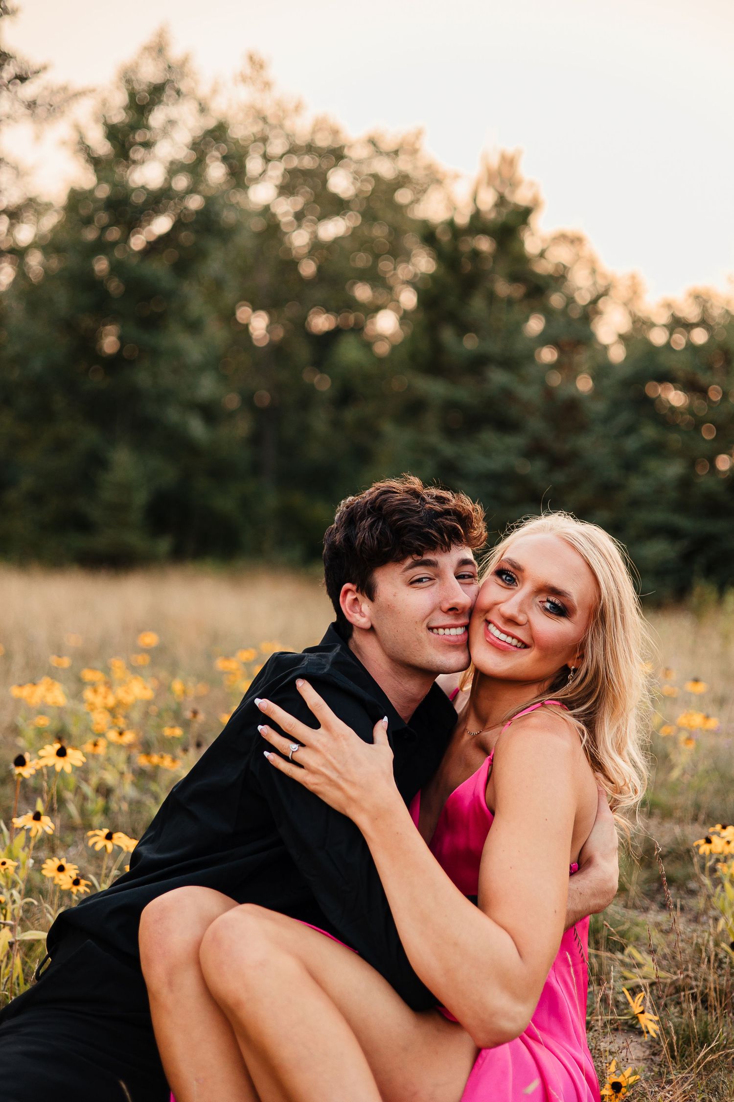 Bemidji couple smiles during engagement session in local flower field.