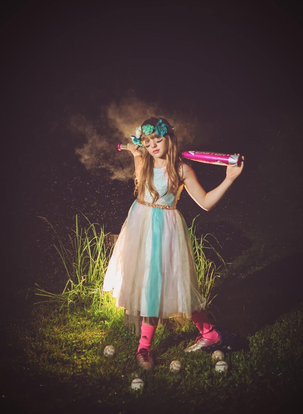 Whimsical portrait of young dancer in tulle dress with colored powder effect.