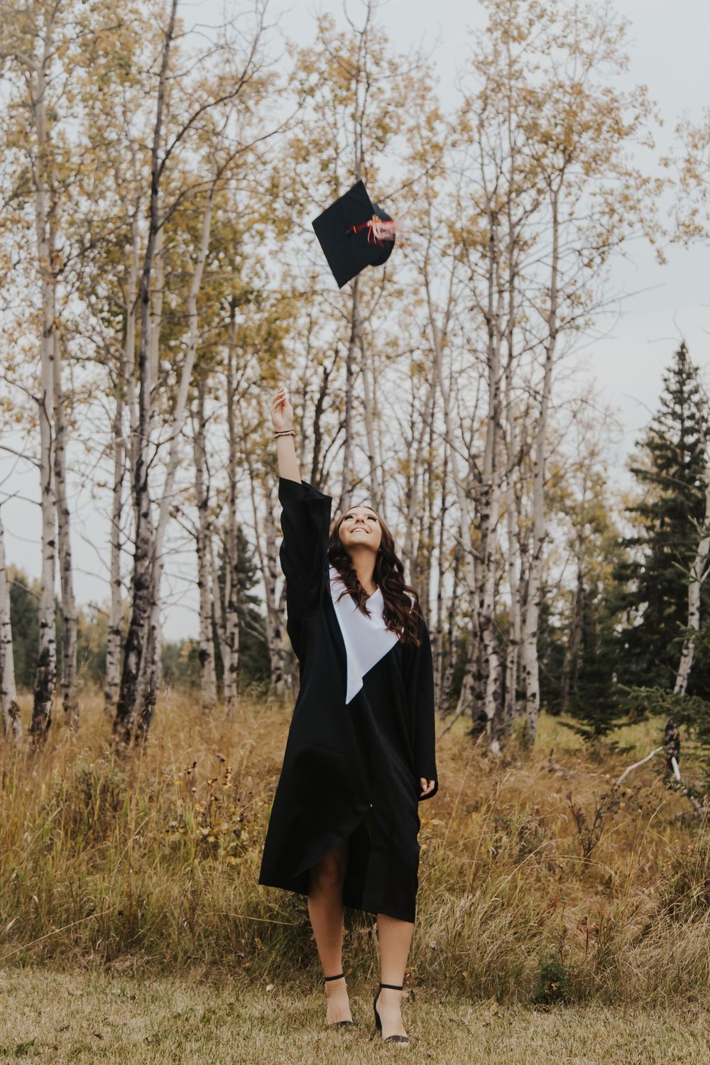 Graduate tosses cap into the air