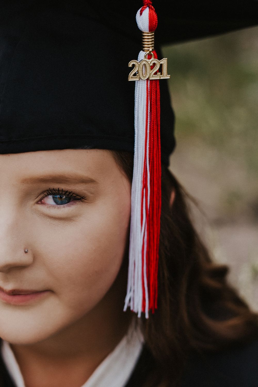 Girl in 2021 grad cap smiles