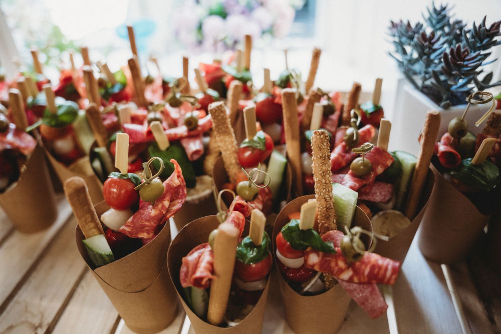 Wedding dessert display featuring multiple small treats in individual paper holders.