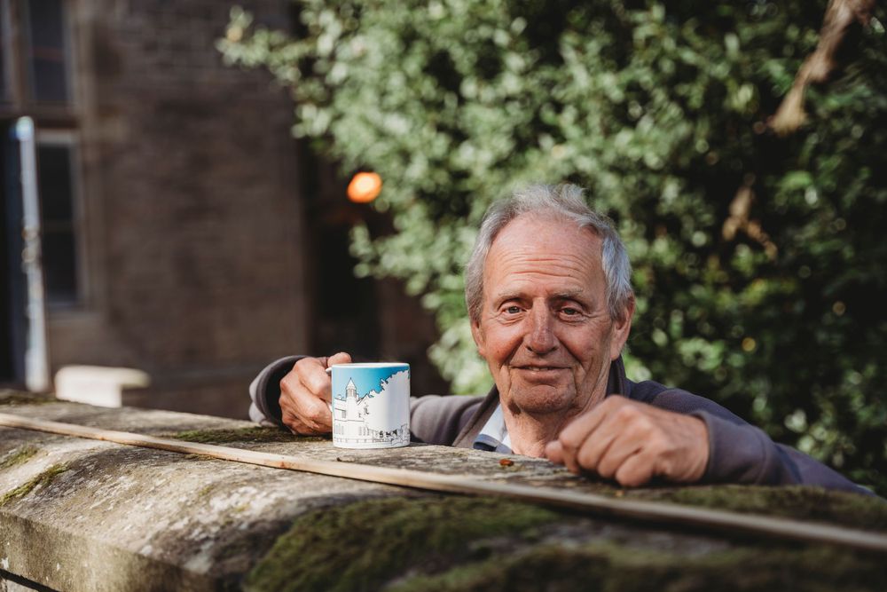 Casual outdoor gathering with refreshments in garden setting.