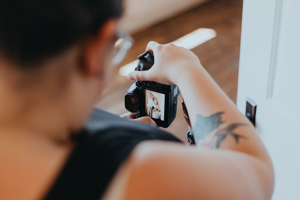 Close-up view of photographers holding cameras during a photoshoot.