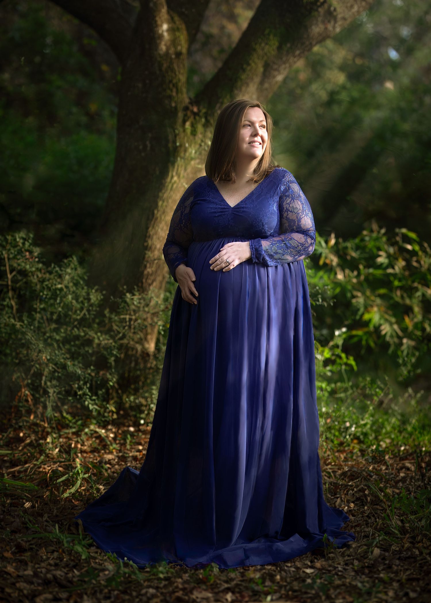 Elegant Maternity Portrait in Blue Dress with Natural Light and Outdoor Scenery