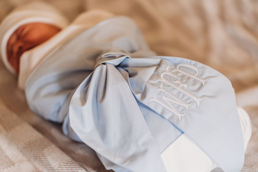 Newborn baby wrapped in soft blue swaddling blanket with embroidered details. fresh 48 / newborn photographer , rapides hospital