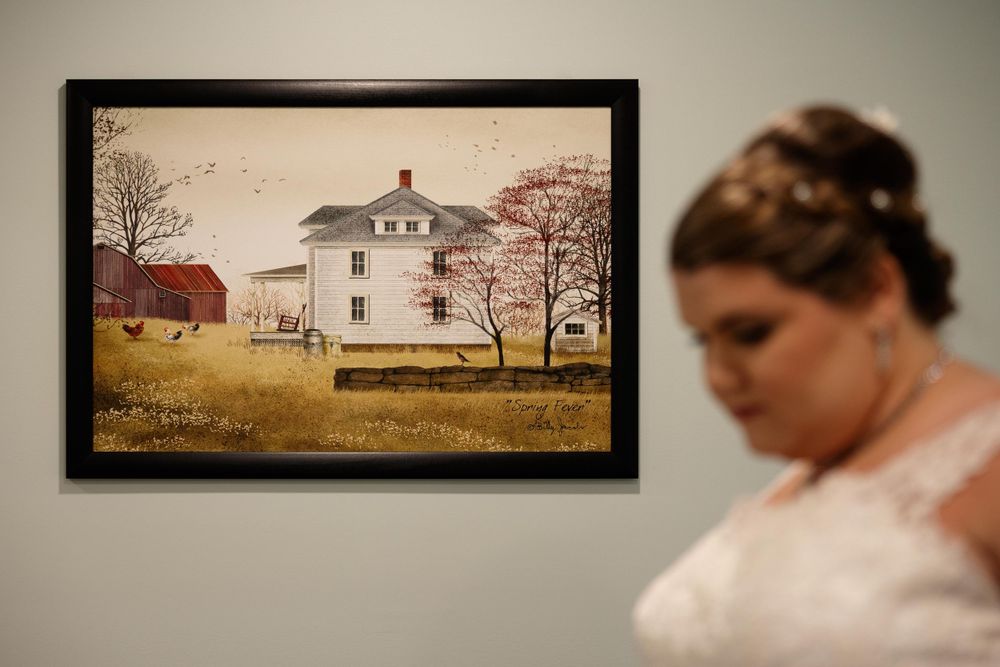 Framed rustic farmhouse artwork with person in wedding dress in foreground.